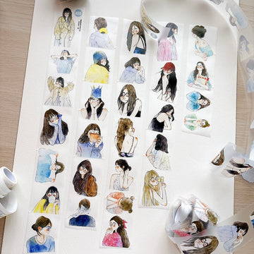 Little portraits tape strips laid out on paper