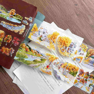 Die-cut washi tape featuring a golden ginkgo-lined street scene with houses and a canal